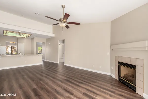 a view of a room with wooden floor and a fireplace