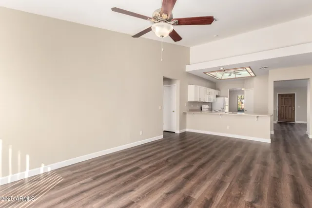 a view of a kitchen with wooden floor and a kitchen space with a sink