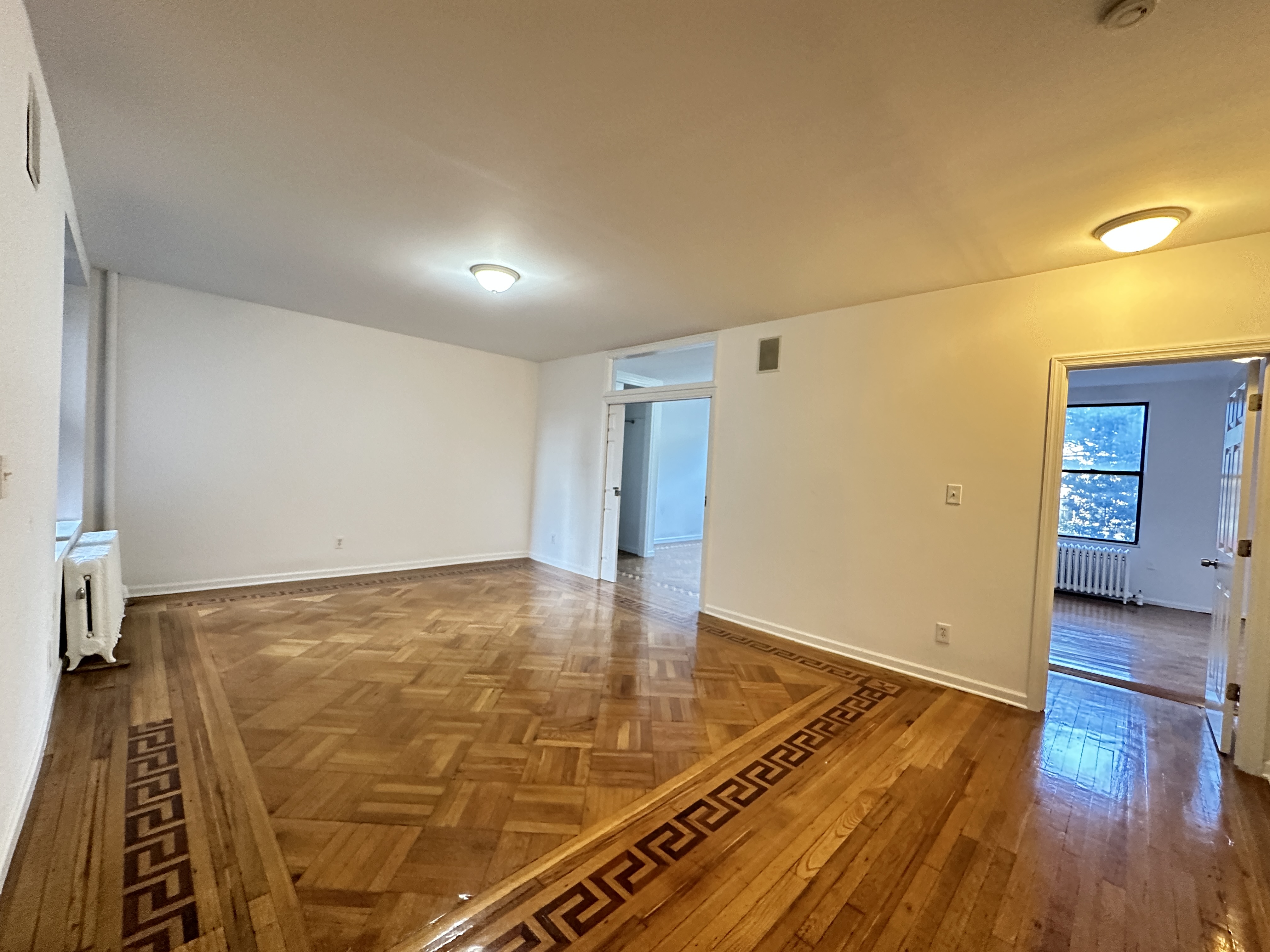 601 West 149th Street, Unit 35 Manhattan, NY 10031 - Photo 3 of 9 a view of an empty room with wooden floor