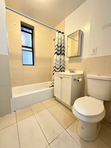 a bathroom with a toilet a sink and bathtub