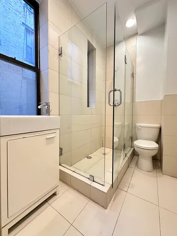 a bathroom with a shower and a sink