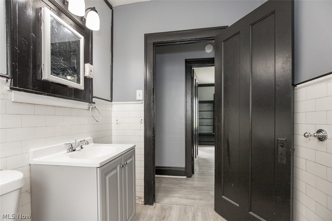 1868-1870 Lampson Road Cleveland, OH 44112 - Photo 29 of 36 Bathroom featuring a single vanity with a white countertop and chrome faucet