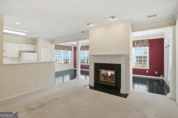 a view of an empty room with a kitchen
