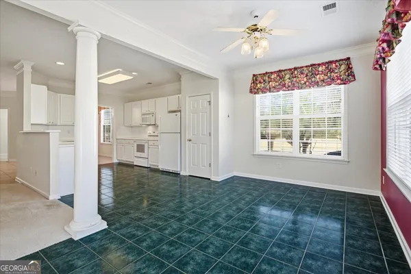 a kitchen with white cabinets and white appliances