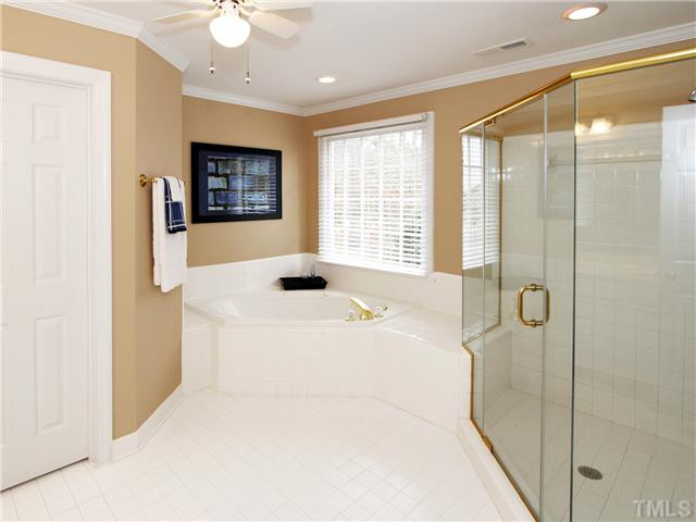 2021 Carrbridge Way Raleigh, NC 27615 - Photo 18 of 25 ANOTHER VIEW OF THE MASTER BATH FEATURING A LARGE WALK-IN SHOWER AND A JACUZZI TUB. NOTE LARGE WINDOW AND CEILING FAN. Master Bath/Spa