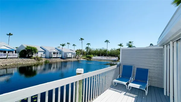 a view of house with outdoor seating and lake view