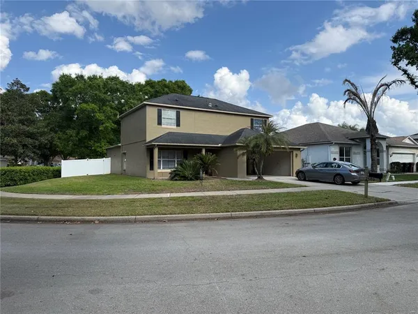 a front view of a house with a yard and entertaining space