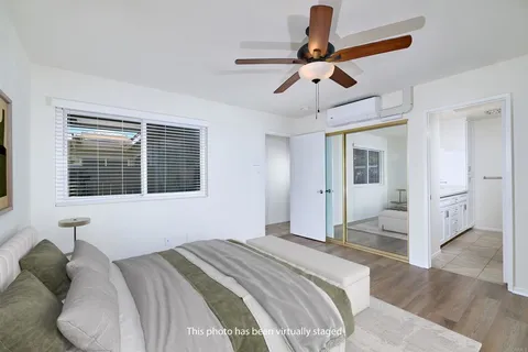 a bedroom with a bed and a large window