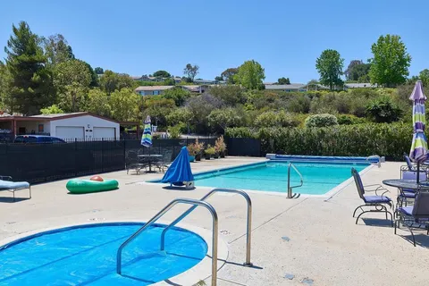 a view of a backyard with sitting area