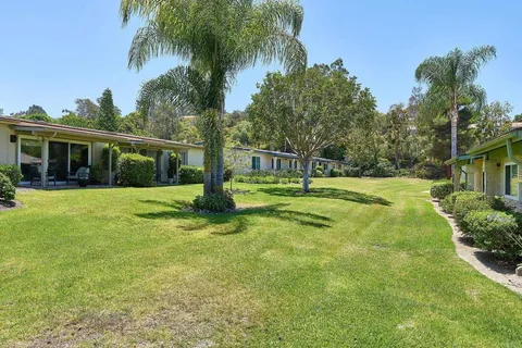 a view of a house with a small yard