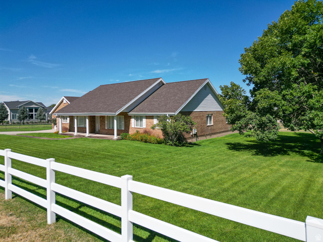 1060 West 2620th Street South Mapleton, UT 84664 - Photo 53 of 87 Ranch-style house featuring a fenced front yard, a porch, and brick siding