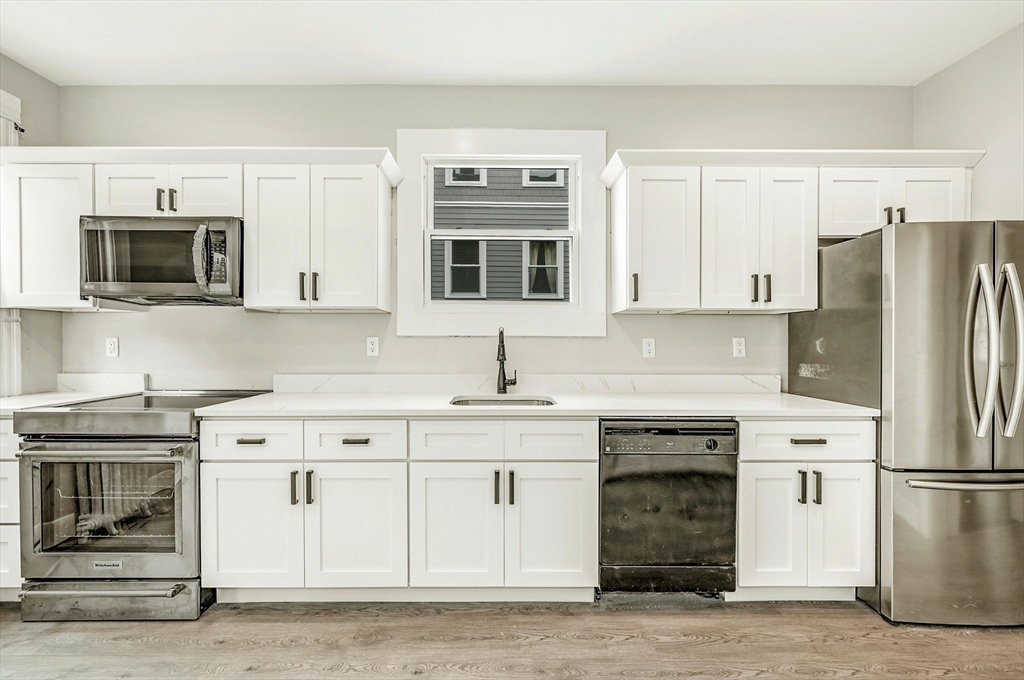 34 William Street Worcester, MA 01609 - Photo 11 of 41 a kitchen with stainless steel appliances granite countertop a stove a microwave and a refrigerator