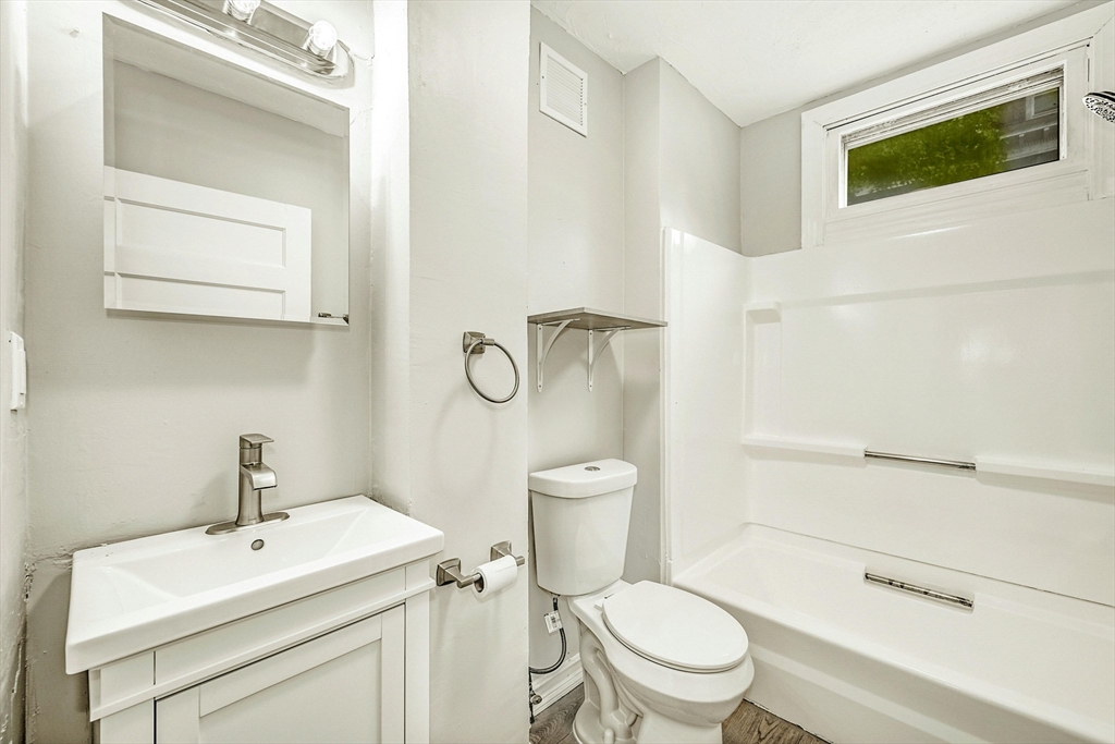 34 William Street Worcester, MA 01609 - Photo 13 of 41 a bathroom with a sink a toilet and shower