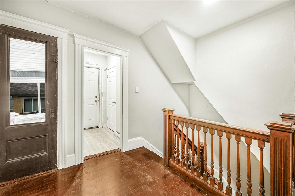 34 William Street Worcester, MA 01609 - Photo 14 of 41 a view of a hallway with wooden floor and staircase
