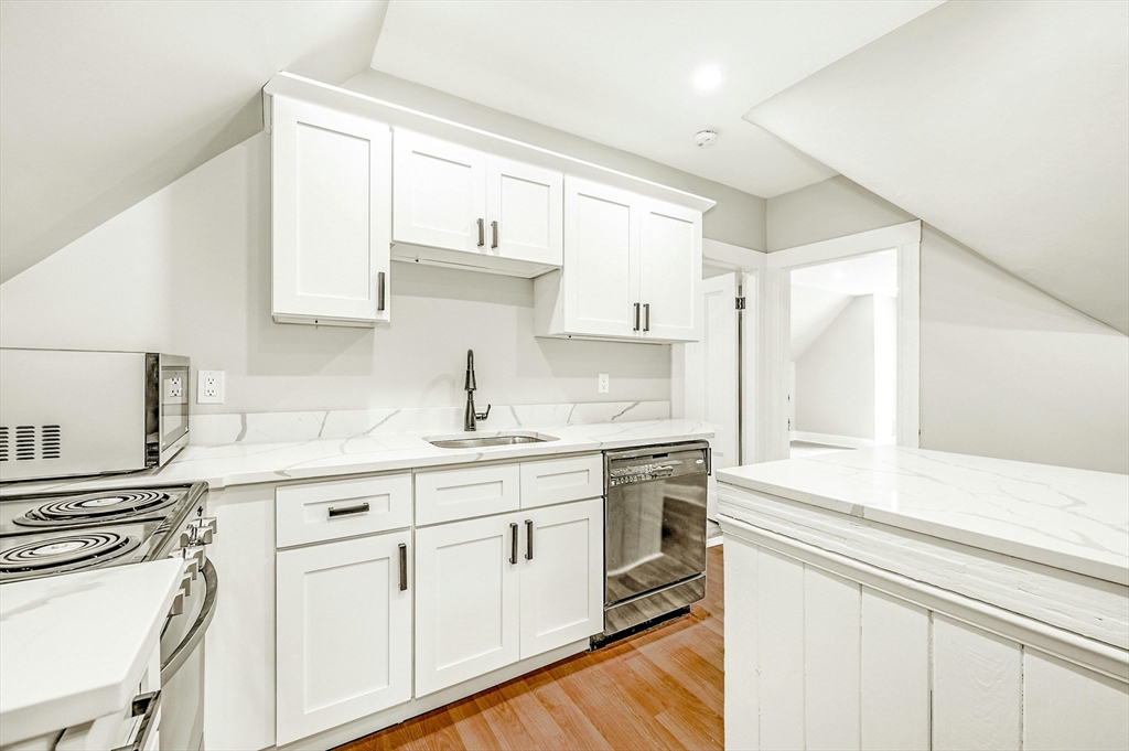 34 William Street Worcester, MA 01609 - Photo 16 of 41 a kitchen with granite countertop white cabinets and white appliances