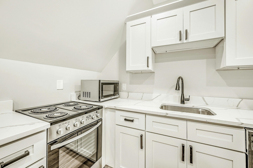 34 William Street Worcester, MA 01609 - Photo 17 of 41 a kitchen with cabinets appliances and a sink