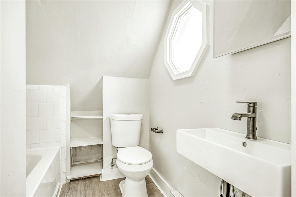 34 William Street Worcester, MA 01609 - Photo 20 of 41 a white toilet sitting next to a bathroom sink