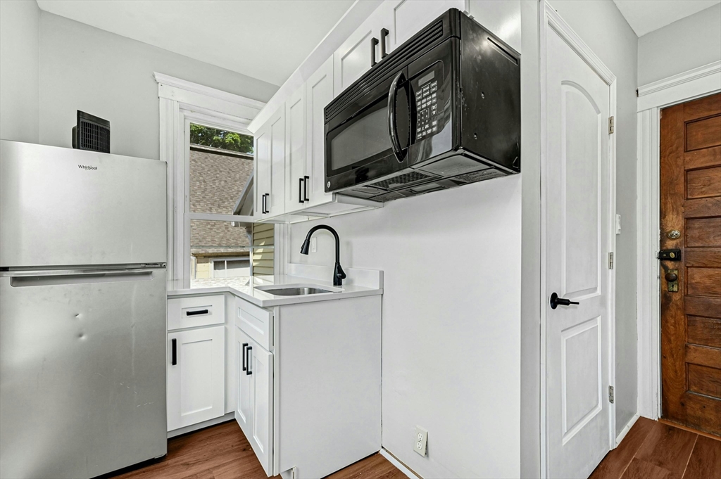 34 William Street Worcester, MA 01609 - Photo 22 of 41 a kitchen with stainless steel appliances a refrigerator sink and microwave