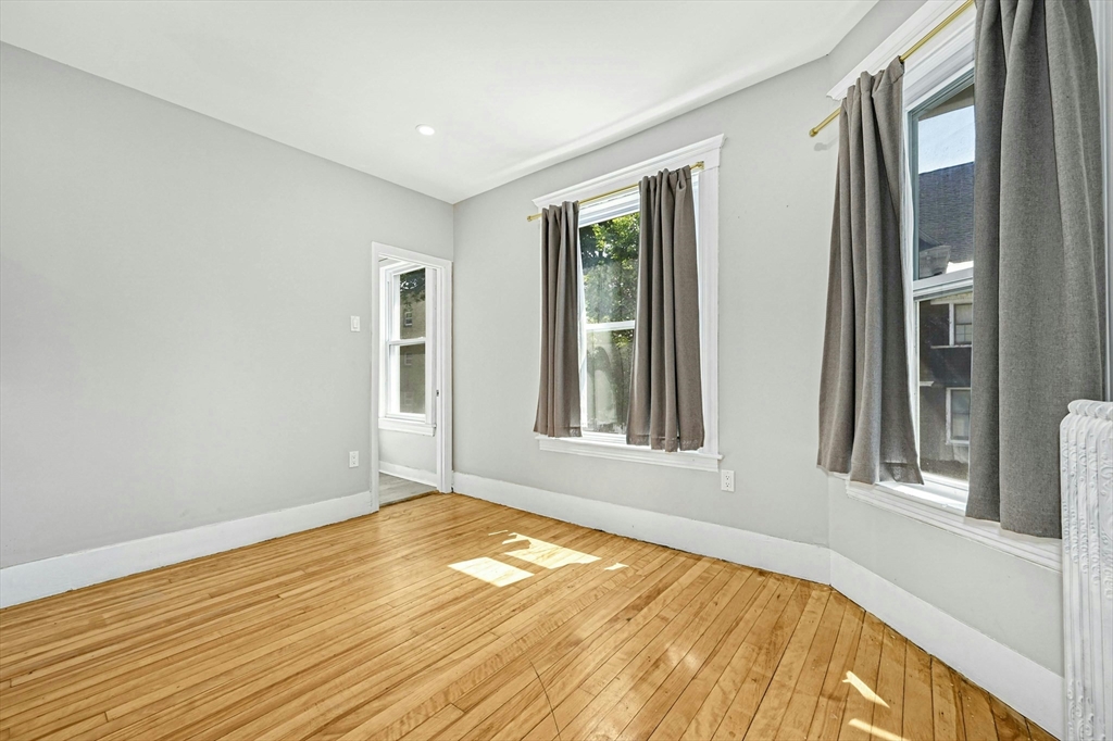 34 William Street Worcester, MA 01609 - Photo 26 of 41 a view of an empty room with wooden floor and a window