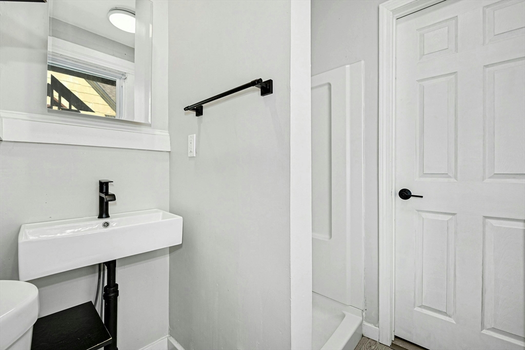 34 William Street Worcester, MA 01609 - Photo 27 of 41 a bathroom with a sink a mirror and a vanity