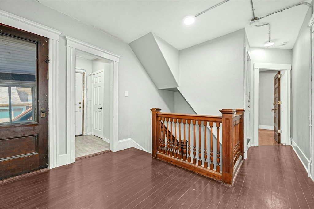 34 William Street Worcester, MA 01609 - Photo 29 of 41 a view of a hallway with wooden floor and stairs