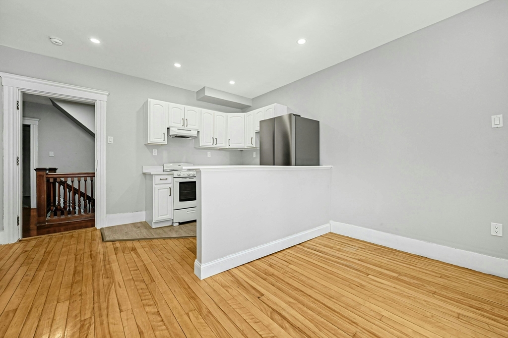 34 William Street Worcester, MA 01609 - Photo 31 of 41 a view of a kitchen with wooden floor and a refrigerator