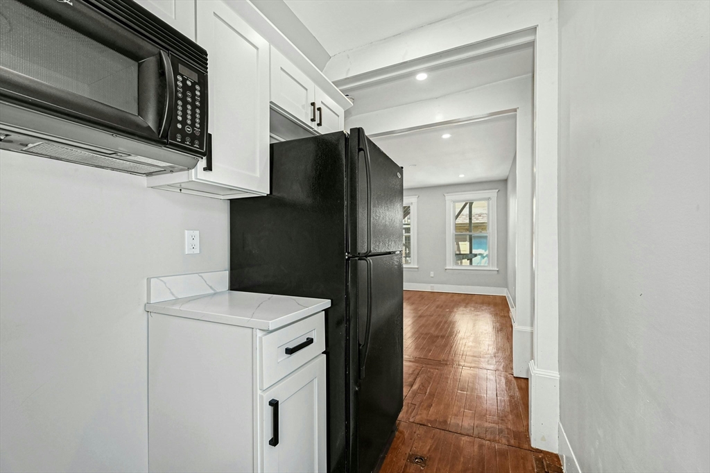34 William Street Worcester, MA 01609 - Photo 32 of 41 a kitchen with a refrigerator and cabinets