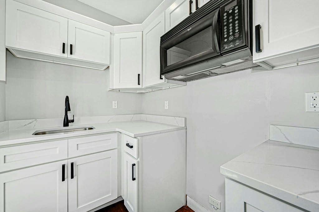 34 William Street Worcester, MA 01609 - Photo 34 of 41 a kitchen with a sink stove and microwave