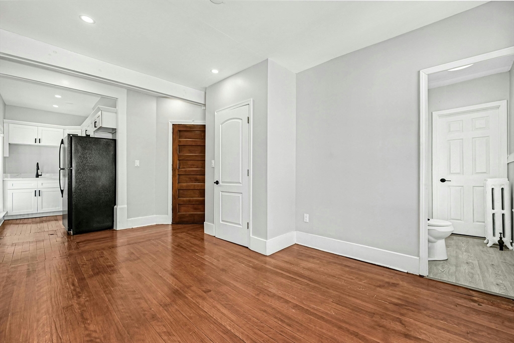 34 William Street Worcester, MA 01609 - Photo 35 of 41 a view of empty room with wooden floor and window