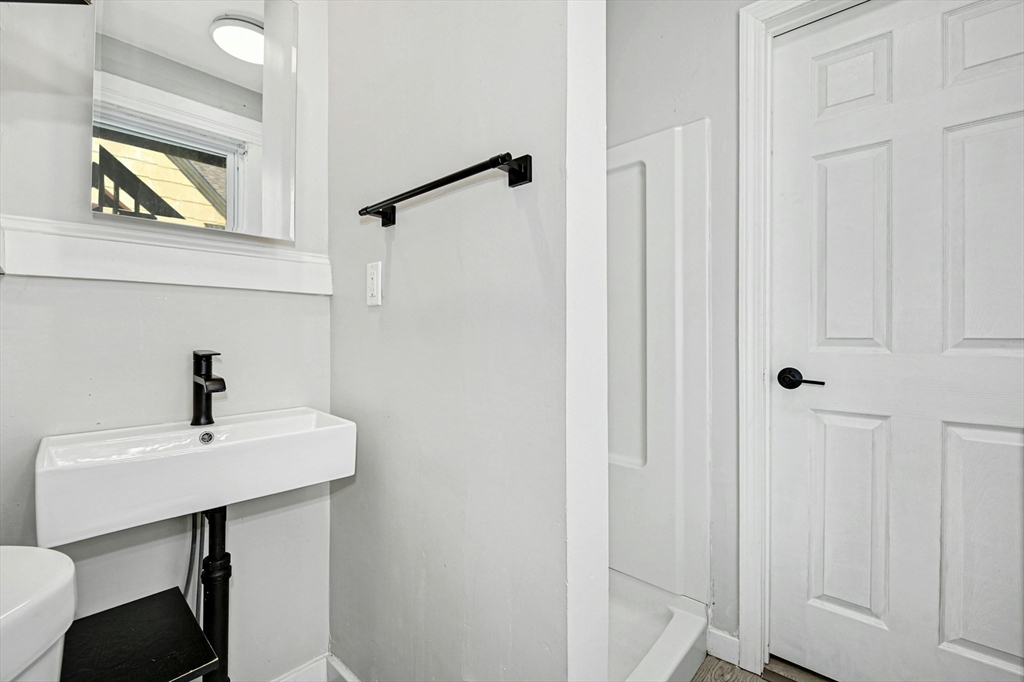 34 William Street Worcester, MA 01609 - Photo 39 of 41 a bathroom with a sink a mirror and a vanity