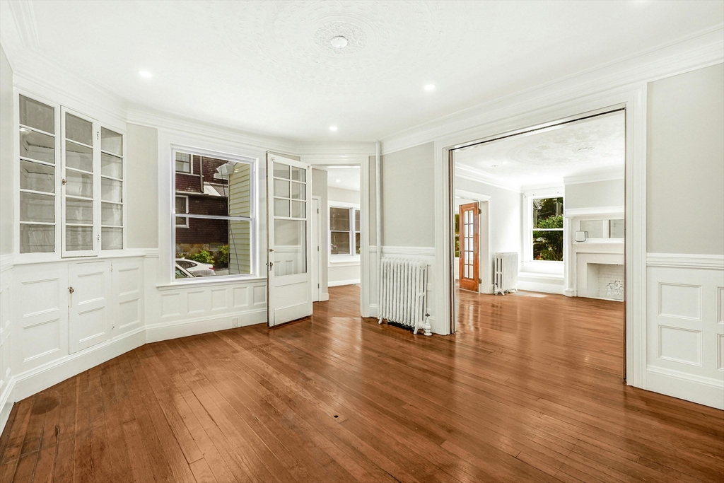 34 William Street Worcester, MA 01609 - Photo 4 of 41 an empty room with wooden floor and windows