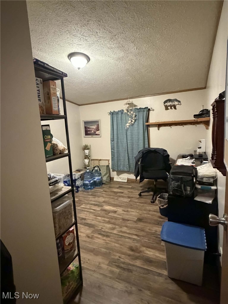 56 3rd Street Rayland, OH 43943 - Photo 44 of 46 Office area with dark wood-style floors, a textured ceiling, and a chandelier