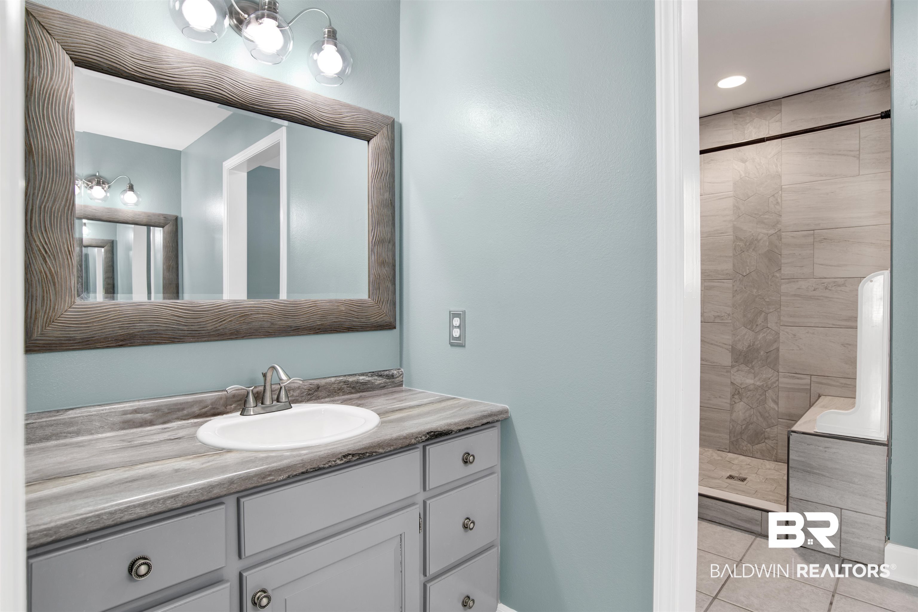 11835 Island Drive Foley, AL 36535 - Photo 16 of 53 Bathroom featuring vanity, a stall shower, and light tile patterned floors