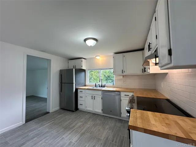 a kitchen with stainless steel appliances granite countertop a sink and a stove