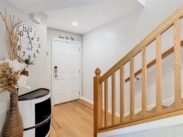 a view of entryway with a potted plant and wooden floor
