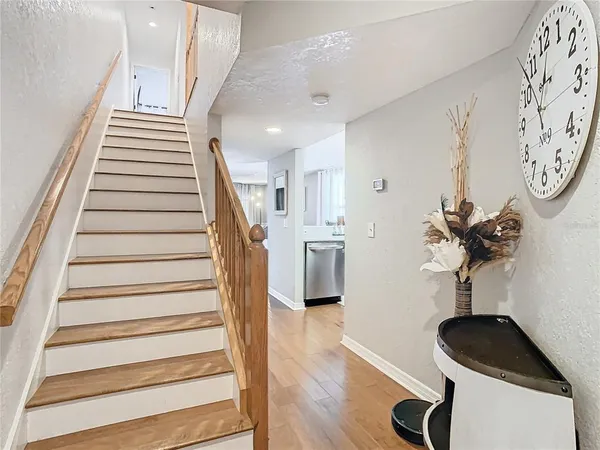 a view of entryway and hall with wooden floor