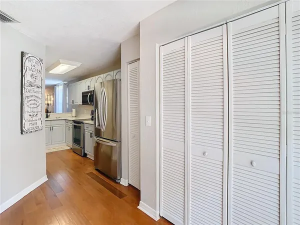 a kitchen with refrigerator cabinets and stainless steel appliances