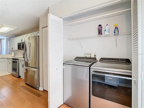 a kitchen with a refrigerator and a stove