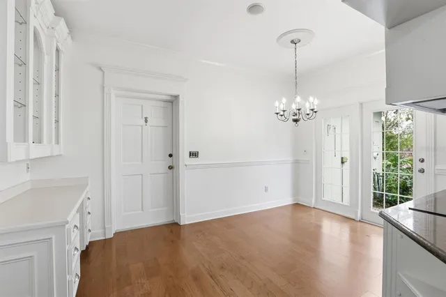 a view of a bedroom with a sink and chandelier