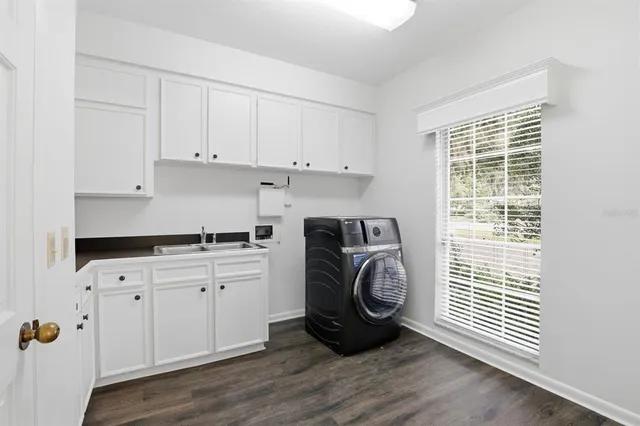 a utility room with sink dryer and washer