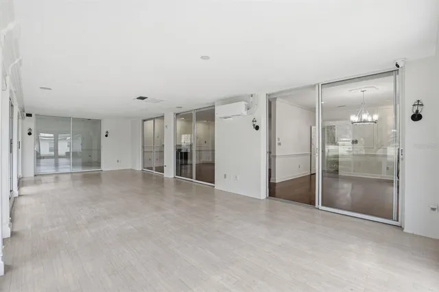 a view of empty room with large windows