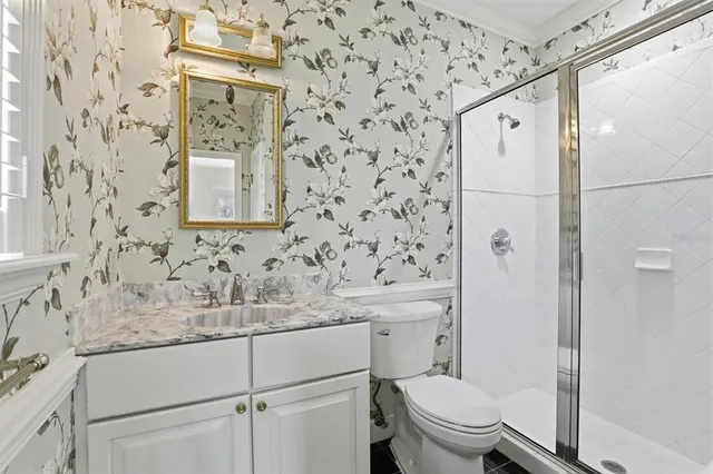 a bathroom with a sink toilet and shower