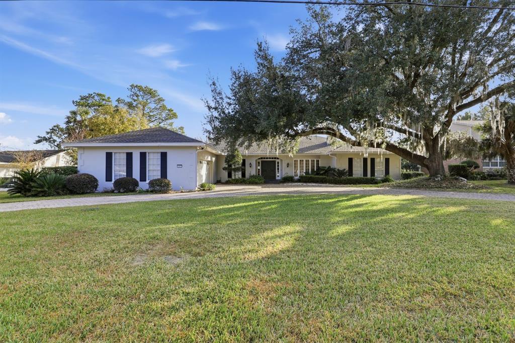 6307 Southwest 35th Way Gainesville, FL 32608 - Photo 32 of 32 a front view of a house with a garden and yard