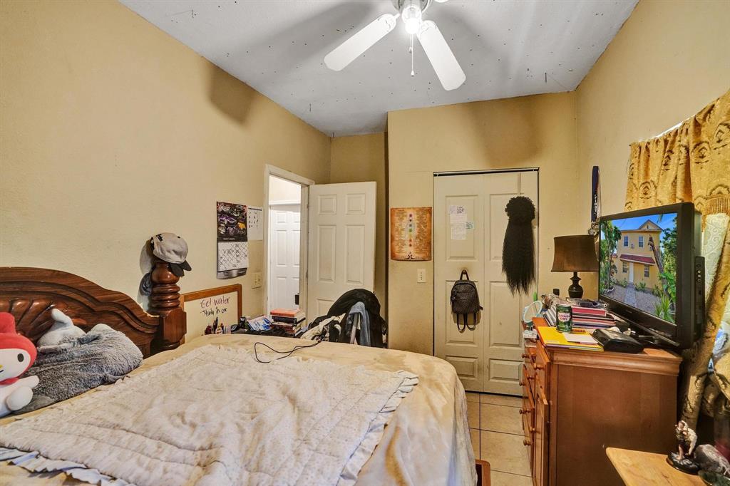 Allapattah Miami, FL 33142 - Photo 29 of 58 a bedroom with a bed furniture and a flat screen tv