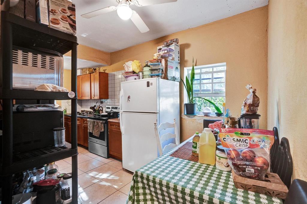 Allapattah Miami, FL 33142 - Photo 30 of 58 a kitchen with a refrigerator and a stove top oven