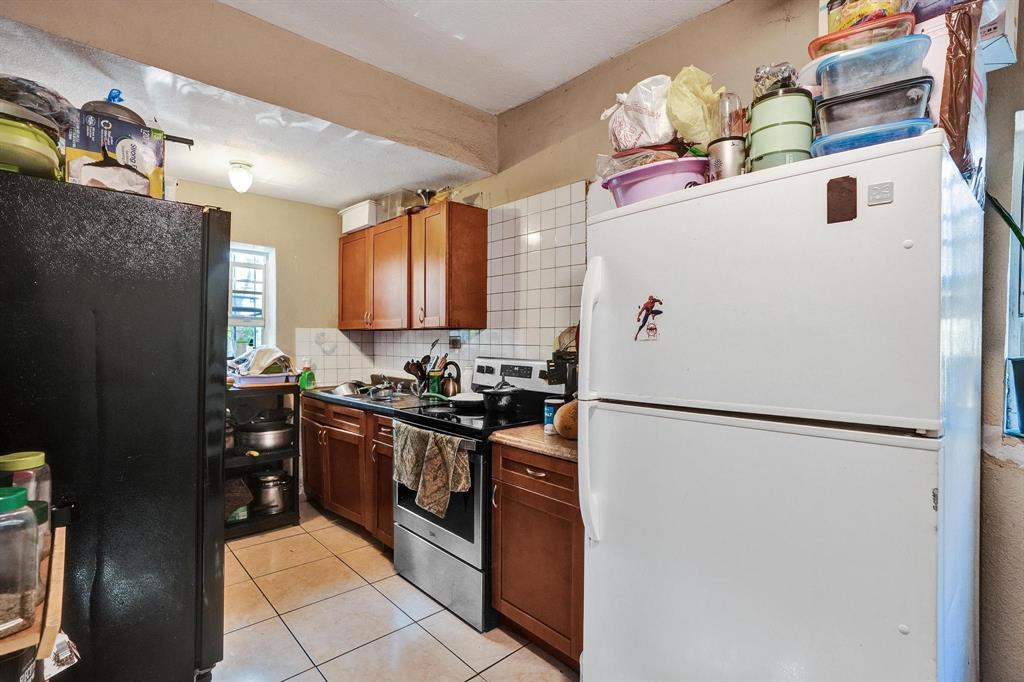 Allapattah Miami, FL 33142 - Photo 31 of 58 a white refrigerator freezer sitting inside of a kitchen