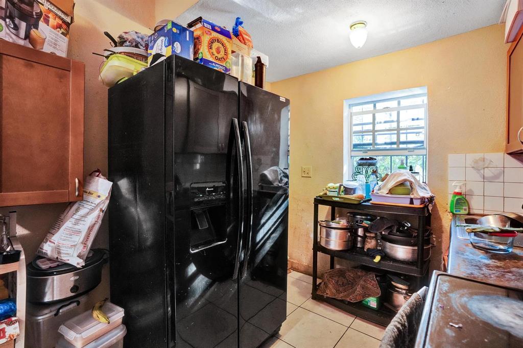 Allapattah Miami, FL 33142 - Photo 32 of 58 a bed room with a bed and a book shelf