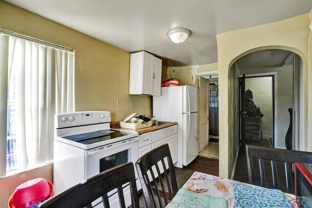 Allapattah Miami, FL 33142 - Photo 39 of 58 a kitchen with stainless steel appliances kitchen island granite countertop a stove a refrigerator and a dining table