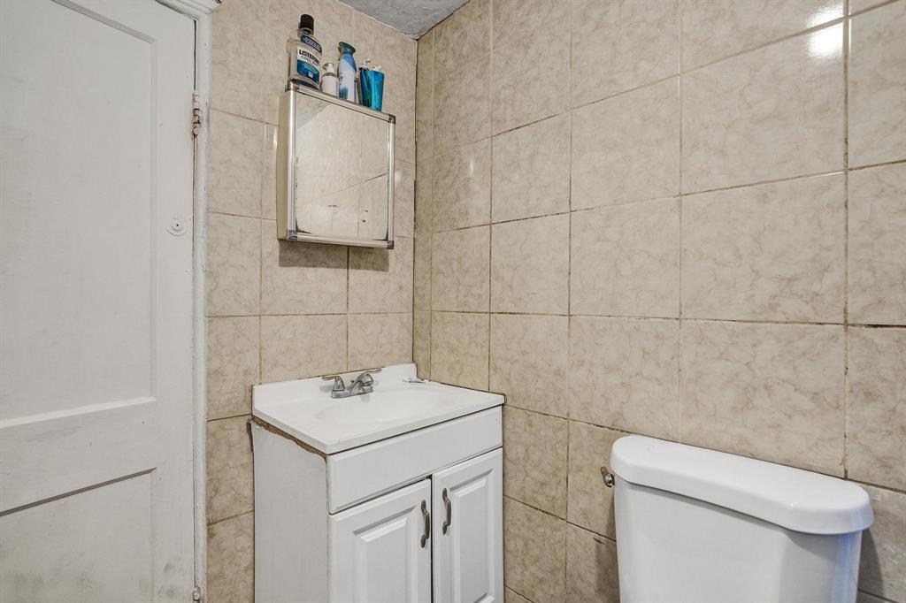 Allapattah Miami, FL 33142 - Photo 41 of 58 a bathroom with a sink toilet and vanity