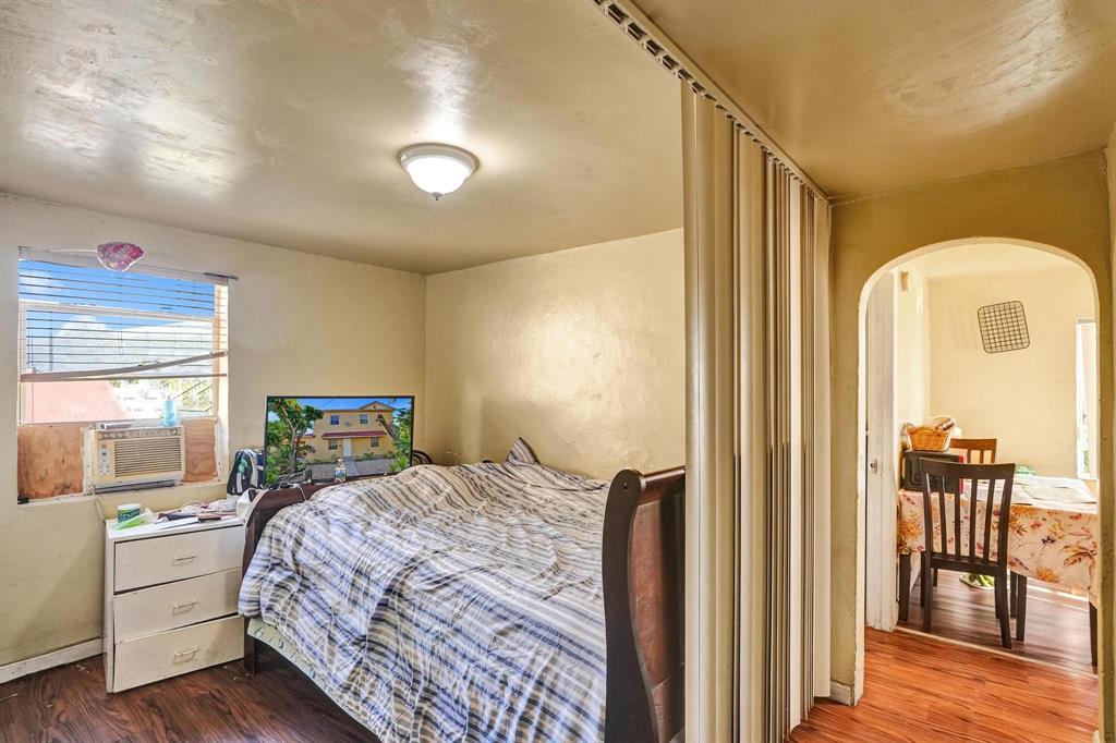 Allapattah Miami, FL 33142 - Photo 43 of 58 a bedroom with a bed and wooden floor